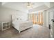 Spacious main bedroom with a tray ceiling, bay window, and plush carpeting at 582 Black Forest Run, Douglasville, GA 30134