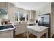 Well-lit kitchen boasts white cabinetry, stainless steel appliances, marble counters and modern fixtures at 586 Collier Rd, Atlanta, GA 30318