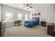 Bedroom featuring a ceiling fan, neutral decor, and a window at 6415 Berkdale Way, Suwanee, GA 30024