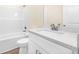 A clean bathroom showcases a white vanity, quartz countertop, and tub-shower combo at 653 Armitage Way, Stockbridge, GA 30281