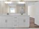 Large bathroom with double vanity, granite countertops, and a mirror at 653 Armitage Way, Stockbridge, GA 30281