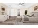 A bright, staged bedroom features wood floors, ceiling fan, and neutral tones at 653 Armitage Way, Stockbridge, GA 30281