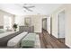 An airy staged bedroom with gray walls and wood floors at 653 Armitage Way, Stockbridge, GA 30281