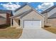 Traditional house with a two-car garage and driveway at 653 Armitage Way, Stockbridge, GA 30281