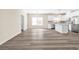 Open concept kitchen with white cabinets, stainless steel appliances, and wood flooring at 653 Armitage Way, Stockbridge, GA 30281
