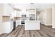 Bright kitchen featuring white cabinetry, stainless steel appliances, and center island at 653 Armitage Way, Stockbridge, GA 30281