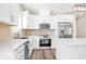 Bright kitchen featuring white cabinetry, stainless steel appliances, and center island at 653 Armitage Way, Stockbridge, GA 30281