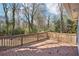 Large backyard deck with wood railing, ideal for entertaining or enjoying the serene wooded surroundings at 1694 Kenmore Sw St, Atlanta, GA 30311