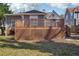 This wood deck has a railing and overlooks the backyard at 1694 Kenmore Sw St, Atlanta, GA 30311