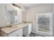 Bright bathroom featuring granite countertops and double sinks at 1694 Kenmore Sw St, Atlanta, GA 30311