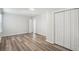 Bedroom featuring neutral walls, wood-look flooring, closet, and natural light from the windows at 1694 Kenmore Sw St, Atlanta, GA 30311