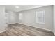 Bedroom featuring neutral walls, wood-look flooring, and natural light from the windows at 1694 Kenmore Sw St, Atlanta, GA 30311