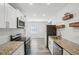 Bright kitchen with stainless steel appliances, granite countertops, and white cabinets at 1694 Kenmore Sw St, Atlanta, GA 30311