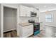 Modern kitchen featuring white cabinets, stainless steel appliances, and granite countertops at 1694 Kenmore Sw St, Atlanta, GA 30311