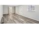 Bright living room featuring sleek gray vinyl flooring, white walls, and a large window for natural light at 1694 Kenmore Sw St, Atlanta, GA 30311