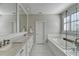 Bright bathroom featuring a soaking tub, separate shower, and double vanity with quartz countertop at 3601 Ridgeway Rd, Duluth, GA 30096