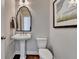 Stylish half-bathroom with pedestal sink, modern fixtures, and framed artwork at 3601 Ridgeway Rd, Duluth, GA 30096