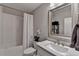 Bathroom featuring a shower-tub combo, toilet, single vanity and large mirror at 3601 Ridgeway Rd, Duluth, GA 30096