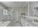 Bright bathroom featuring glass shower and a double vanity with two sinks at 3601 Ridgeway Rd, Duluth, GA 30096