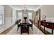 Well-lit dining room with hardwood flooring, elegant chandelier, and ample natural light at 3601 Ridgeway Rd, Duluth, GA 30096