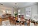 Dining room with a chandelier, hardwood floors, and a decorative rug under a large table at 3601 Ridgeway Rd, Duluth, GA 30096