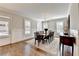 Dining room with hardwood floors, wainscoting, plantation shutters, and an elegant chandelier at 3601 Ridgeway Rd, Duluth, GA 30096