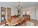 Bright dining room featuring hardwood floors, wainscoting, shuttered windows, and a decorative chandelier at 3601 Ridgeway Rd, Duluth, GA 30096