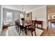 Bright dining room featuring hardwood floors, wainscoting, shuttered windows, and a decorative chandelier at 3601 Ridgeway Rd, Duluth, GA 30096