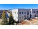 Exterior of a three story townhome with a light-colored brick facade and lush landscaping at 3601 Ridgeway Rd, Duluth, GA 30096