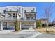 Modern townhome with white brick, attached garages, and private covered balconies at 3601 Ridgeway Rd, Duluth, GA 30096