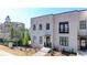 Modern townhome with a light brick facade, dark window trim, and manicured landscaping at 3601 Ridgeway Rd, Duluth, GA 30096