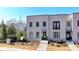 Exterior view of a modern townhome with a white brick facade and neatly maintained front yard landscaping at 3601 Ridgeway Rd, Duluth, GA 30096