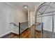 Upstairs hallway featuring hardwood floors, iron railings, and classic decor at 3601 Ridgeway Rd, Duluth, GA 30096