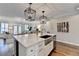 Kitchen boasts a large island with stainless steel sink and modern pendant lighting at 3601 Ridgeway Rd, Duluth, GA 30096