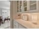 Butler's pantry featuring white cabinets, wine rack and countertop lighting at 3601 Ridgeway Rd, Duluth, GA 30096