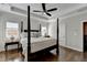 Bedroom with a tray ceiling, a four-poster bed, and hardwood floors at 3601 Ridgeway Rd, Duluth, GA 30096