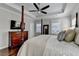 Bedroom with a tray ceiling, dark wooden floors, and a four-poster bed at 3601 Ridgeway Rd, Duluth, GA 30096