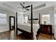 Bedroom with a tray ceiling, a four-poster bed, and hardwood floors at 3601 Ridgeway Rd, Duluth, GA 30096