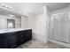 Bright bathroom featuring dual sink vanity, soaking tub, and glass-enclosed shower at 813 Whittington Sw Pkwy, Marietta, GA 30060