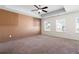 Spacious bedroom with carpet, a tray ceiling, a ceiling fan, and ample natural light from multiple windows at 813 Whittington Sw Pkwy, Marietta, GA 30060