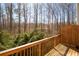 Cozy deck with wood railing overlooking greenery and trees in the backyard at 813 Whittington Sw Pkwy, Marietta, GA 30060
