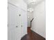 Bright hallway featuring dark hardwood floors, white walls, and modern ceiling lights at 813 Whittington Sw Pkwy, Marietta, GA 30060