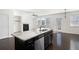 Bright kitchen boasts an island with granite countertops, stainless steel appliances and dark wood floors at 813 Whittington Sw Pkwy, Marietta, GA 30060