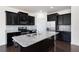Modern kitchen features dark cabinets, stainless steel appliances and granite countertops at 813 Whittington Sw Pkwy, Marietta, GA 30060