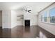 Bright living room features a cozy fireplace, floating shelves and dark hardwood flooring at 813 Whittington Sw Pkwy, Marietta, GA 30060