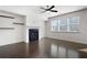 Bright living room features a cozy fireplace, modern ceiling fan and dark hardwood flooring at 813 Whittington Sw Pkwy, Marietta, GA 30060