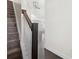 Carpeted stairs with dark stained wood railing, white balusters, and modern chandelier at 813 Whittington Sw Pkwy, Marietta, GA 30060