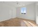 Spacious bedroom with hardwood floors, neutral paint, and a large window creating a serene atmosphere at 145 Hutchinson Ne St, Atlanta, GA 30307