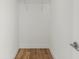 A simple walk-in closet features hardwood floors and a wire rack shelf for organized storage solutions at 145 Hutchinson Ne St, Atlanta, GA 30307