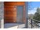 Inviting front porch with a modern gray door, complemented by wood and stone elements at 145 Hutchinson Ne St, Atlanta, GA 30307